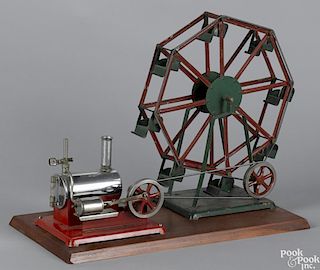 Electric steam engine with a tin ferris wheel, unbranded, mounted on a wood base, 16'' h., 20'' l.