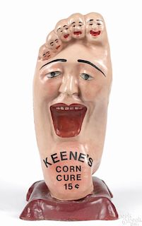 Old King Cole composition advertising display for Keene's Corn Cure, in foot form
