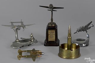 Four metalware airplane desk pieces, to include two ashtrays, one in the form of Australia