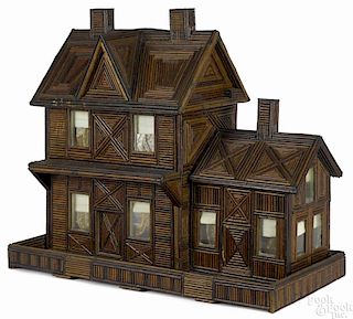 Tramp art doll house with a shellacked twig facade on recycled wood crates