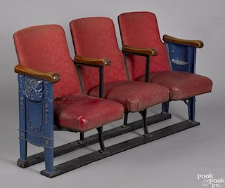 Three theater seats, ca. 1930, with ornate cast iron sides, one having illuminated apertures