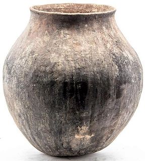 An Earthenware Storage Vessel, Height 17 inches.