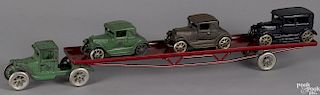 Arcade cast iron flatbed car carrier with three cars and a reproduction trailer, 24 1/2'' l.