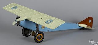Schieble pressed steel single engine passenger plane with original decals depicting passengers