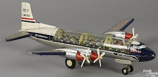 Japanese tin lithograph friction United Airlines DC-7 Mainliner airplane with a clear fuselage