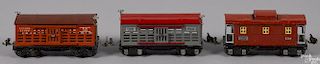 Three Lionel O Gauge freight train cars, to include a no. 657 caboose and two no. 656 cattle cars