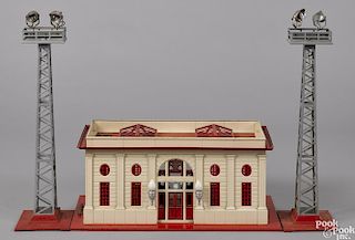 Lionel no. 116 train station and light towers, to include a red and cream electric station