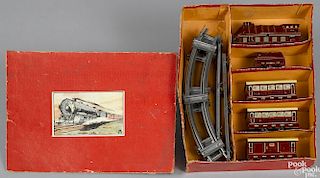 German lithographed tin train set in box, to include a clockwork locomotive, tender, and three cars