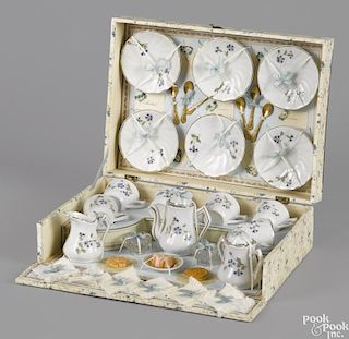 French doll's tea service in a presentation box, complete with napkins and cake, 12 1/2'' w., 9'' d.