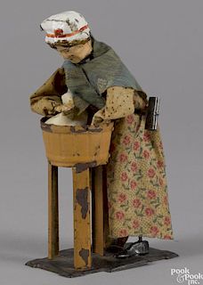 Ferdinand Martin hand painted tin clockwork woman washing clothes, 7 1/4'' h.