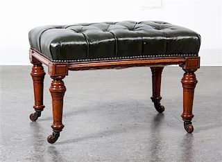 * A Victorian Walnut and Leather Footstool, Height 16 1/2 x width 23 1/2 x depth 15 inches.