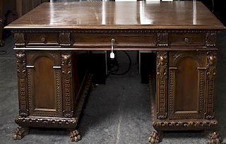A Renaissance Revival Style Walnut Pedestal Desk, Height 32 x width 56 1/2 x depth 30 3/4 inches.