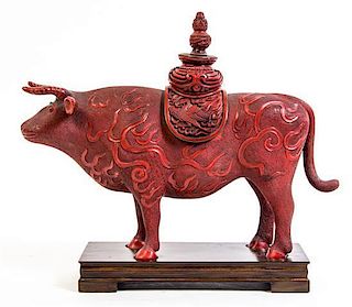 A Cinnabar Style Lacquered Figure of an Ox, Width 14 inches.