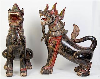 A Pair of Southeast Asian Carved Wood Temple Lions, Height of each 30 inches.
