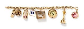 A 14 Karat Yellow Gold Charm Bracelet with Eight Attached Charms, 42.10 dwts.