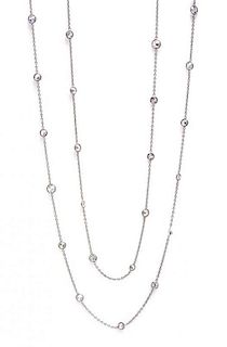 An 18 Karat White Gold and Diamond Station Necklace, 6.40 dwts.