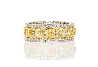 A Platinum, Yellow Gold, Fancy Yellow Diamond and Diamond Eternity Band Ring, 7.90 dwts.