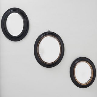 Group of Three Small Oval Ebonized and Brass Convex Mirrors 