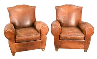 A Pair of Brown Leather Easy Chairs and Ottomans