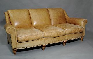 Three cushion light brown leather sofa on turned legs