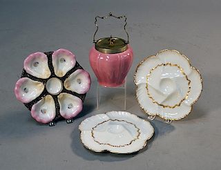 Three oyster plates and a pink biscuit jar, two Haviland; one Limoges, four pieces total