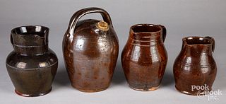 Three redware pitchers and a harvest pitcher