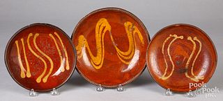 Three Pennsylvania redware plates, 19th c.