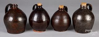 Four redware jugs, 19th c.