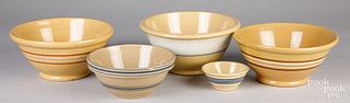 Five yellowware mixing bowls