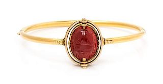 An Egyptian Revival Yellow Gold, Carved Carnelian Scarab and Enamel Bangle Bracelet, Carlo Giuliano, 8.50 dwts.