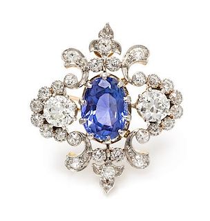An Edwardian Platinum Topped Gold, Sapphire and Diamond Fleur-de-lys Brooch, 5.90 dwts.