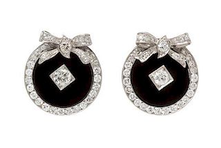 A Pair of Platinum, Diamond and Onyx Earclips, 8.70 dwts.