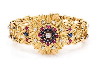 An 18 Karat Yellow Gold Diamond, Ruby and Sapphire Surprise Watch Bracelet, 60.30 dwts.
