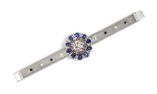 An 18 Karat White Gold, Sapphire, Ruby and Diamond Surprise Wristwatch, 39.10 dwts.