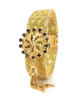 * An 18 Karat Yellow Gold and Sapphire Surprise Wristwatch, Nava, 28.40 dwts.