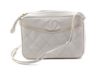 * A Chanel Cream Lizard Handbag, 7" x 5" x 2".