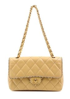 * A Chanel Cream Single Flap Quilted Handbag, 10" x 6" x 2".