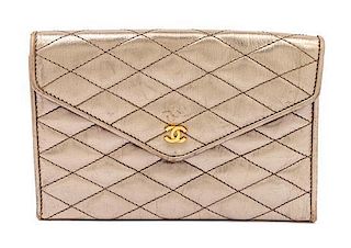 * A Chanel Gold Quilted Wallet, 6.5" x 4.5" x 1.5".
