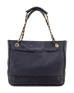 * A Chanel Navy Canvas and Leather Tote Handbag, 12" x 9" x 2".