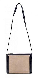 * An Hermes Navy Leather and Canvas Handbag, 9" x 7 3/4" x 3".