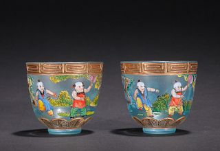 PAIR OF GLASS CARVED FIGURE PATTERN CUPS