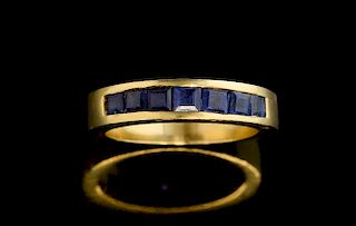 Modern channel set ring set with square cut sapphires, unmarked yellow metal