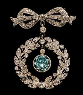 Edwardian wreath and bow brooch, with diamonds in  white gold milgrain setting and central blue zircon drop, 3 cm,  in Asprey