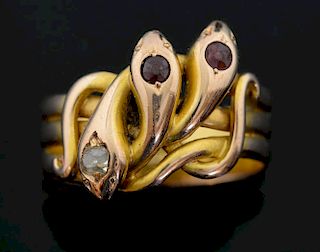 Edwardian gold triple snake ring set with garnet and diamond set heads. Mounted in 18 ct gold.