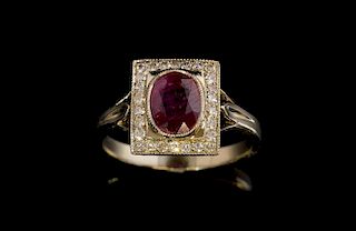 Ruby and diamond cluster ring, set with an oval cut ruby within a diamonds set border mounted in white gold, tested as 18 ct.
