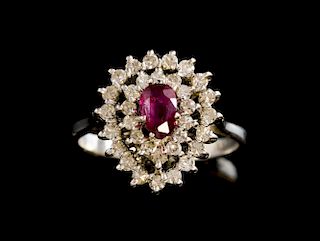 Ruby and diamond cluster ring, in a pear shape, the central ruby within  a diamond surround, 18 ct white gold.