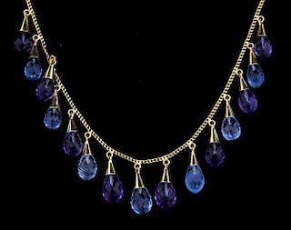 Blue topaz and amethyst necklace set with briolette cut alternating blue topaz and amethyst drops on a gold chain, in 14ct go