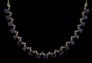 Sapphire and diamond fringe necklace, set with nineteen oval cut sapphires with a diamond detail to the top. Mounted in 14 ct