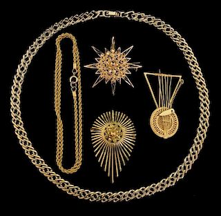 Note one necklace gold plated , test  Fine gold, two chains and three eastern motif brooches, all testing as high carat 18-22