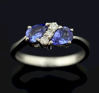 Tanzanite and diamond ring, set with three round brilliant cut diamond to the centre and a pear shape tanzanite to each side,